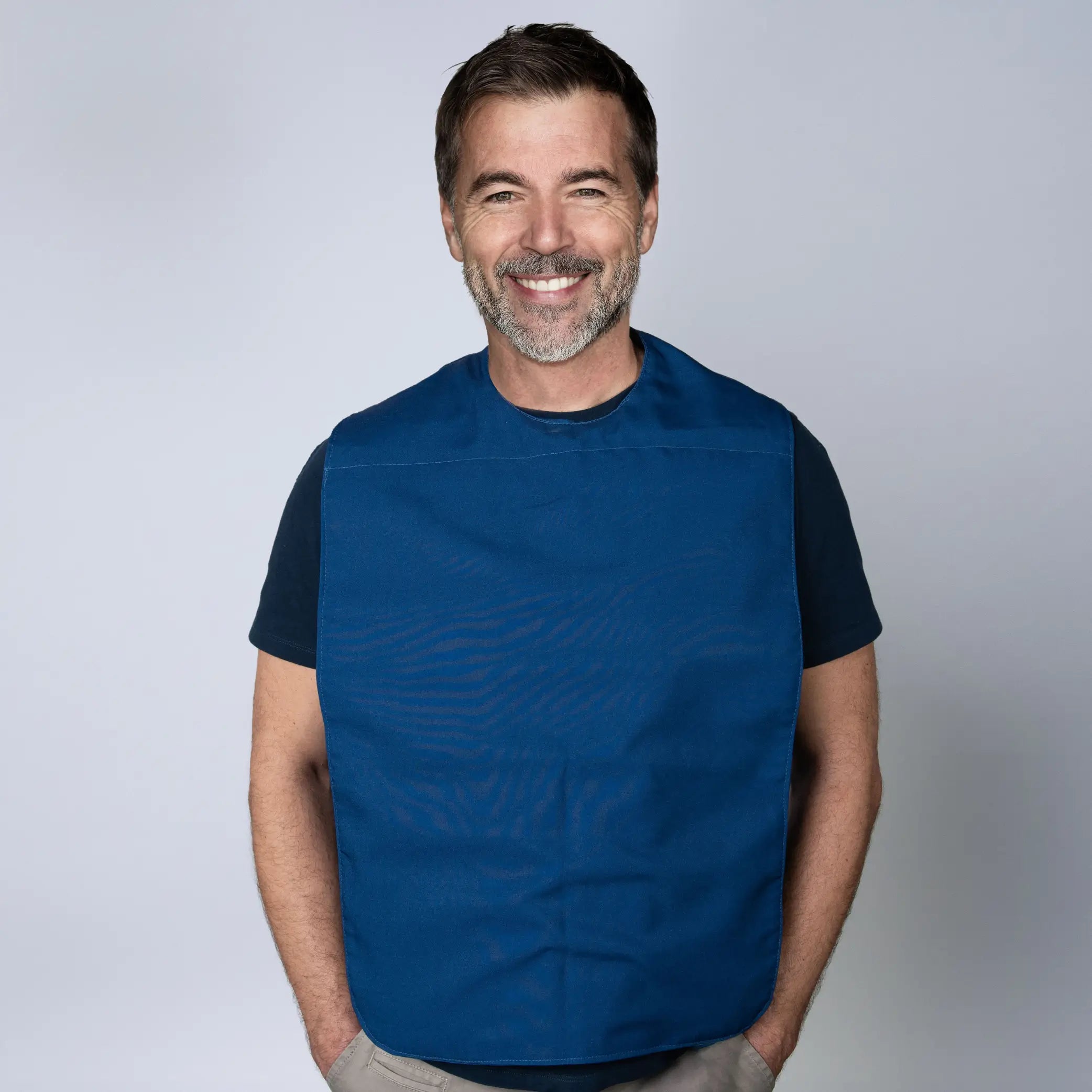 Man wearing a navy Staydry absorbent and waterproof clothing protector for adults and seniors. Provides discreet, full coverage protection against spills and leaks.