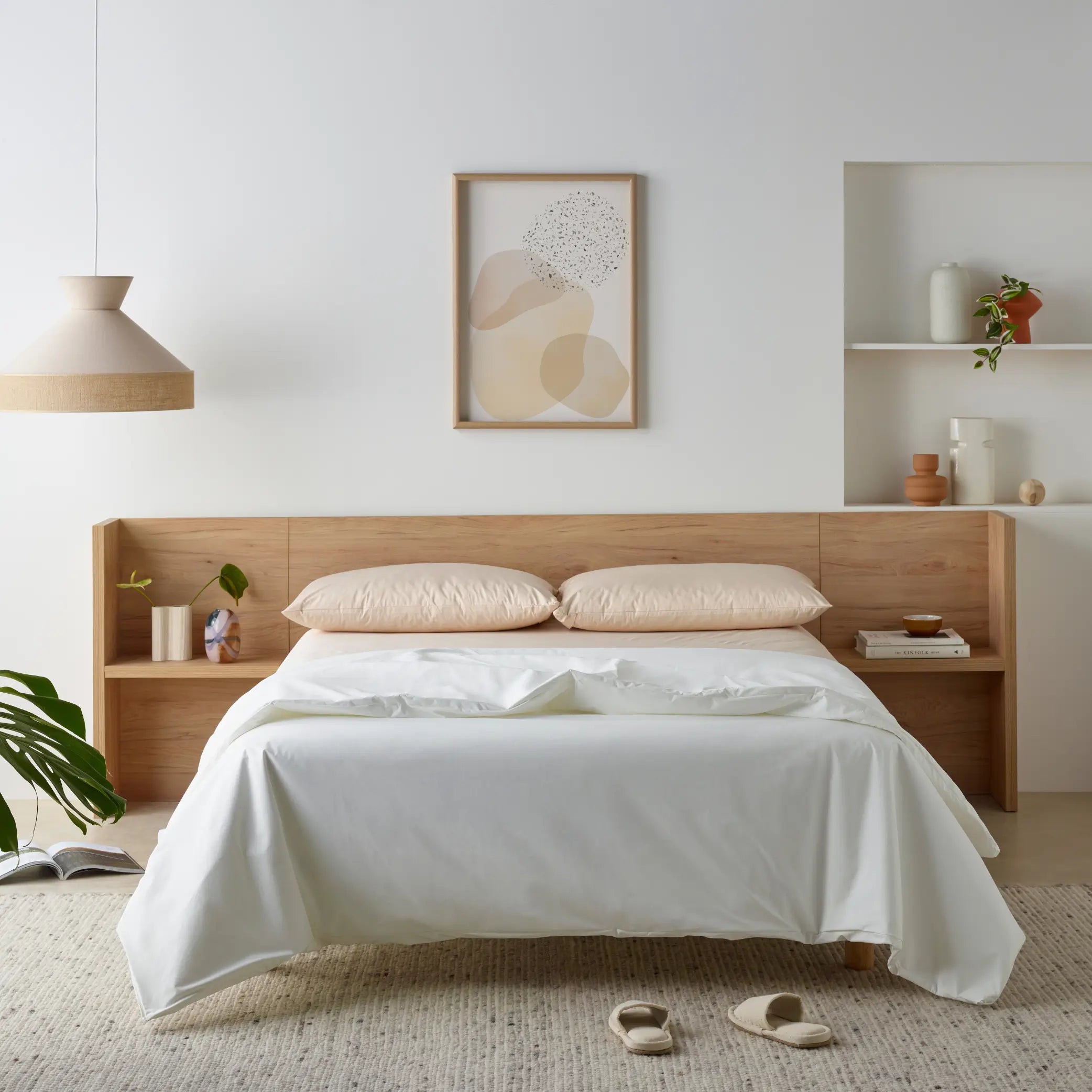 Minimalist bedroom featuring the Duratherme Waterproof Quilt in crisp white. Designed for protection and comfort, this waterproof bedding offers a sleek, modern look while safeguarding against spills and moisture. Styled with neutral pillows, wooden bedside tables, and soft lighting for a serene aesthetic.