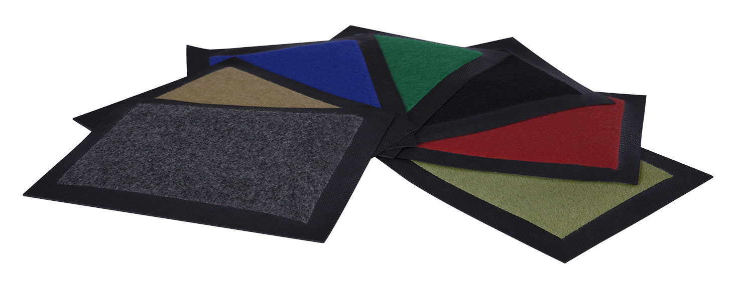 Floor mats laid out displaying their colours being Charcoal, Berige, Blue, Green & Black