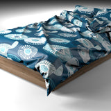 Blue printed quilt cover on a bed